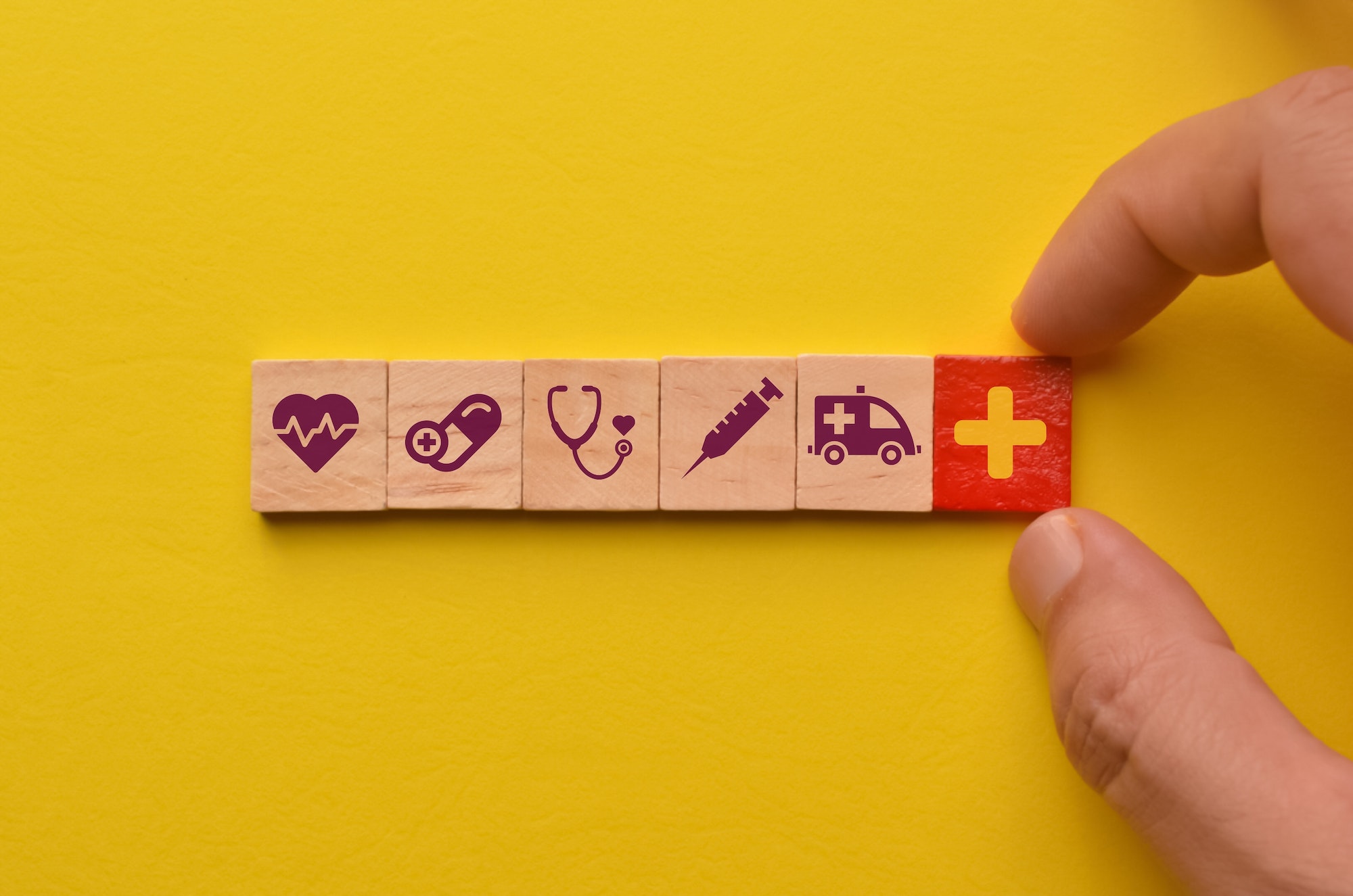 Conceptual of healthcare. Wooden cube blocks with healthcare icons.